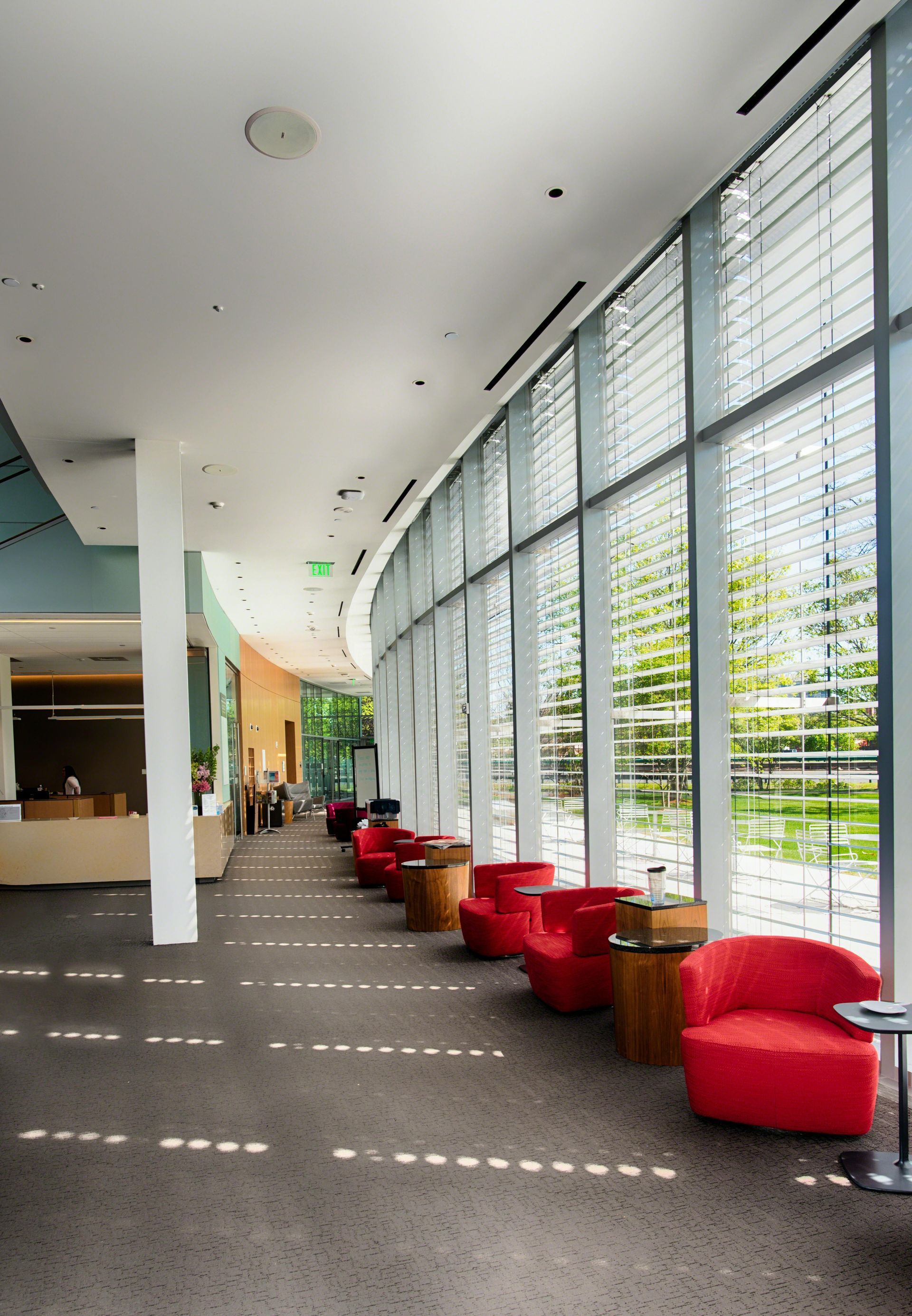 Office building lobby with large windows and chairs for guests that is cleaned by Janitors representing Lenexa, KS