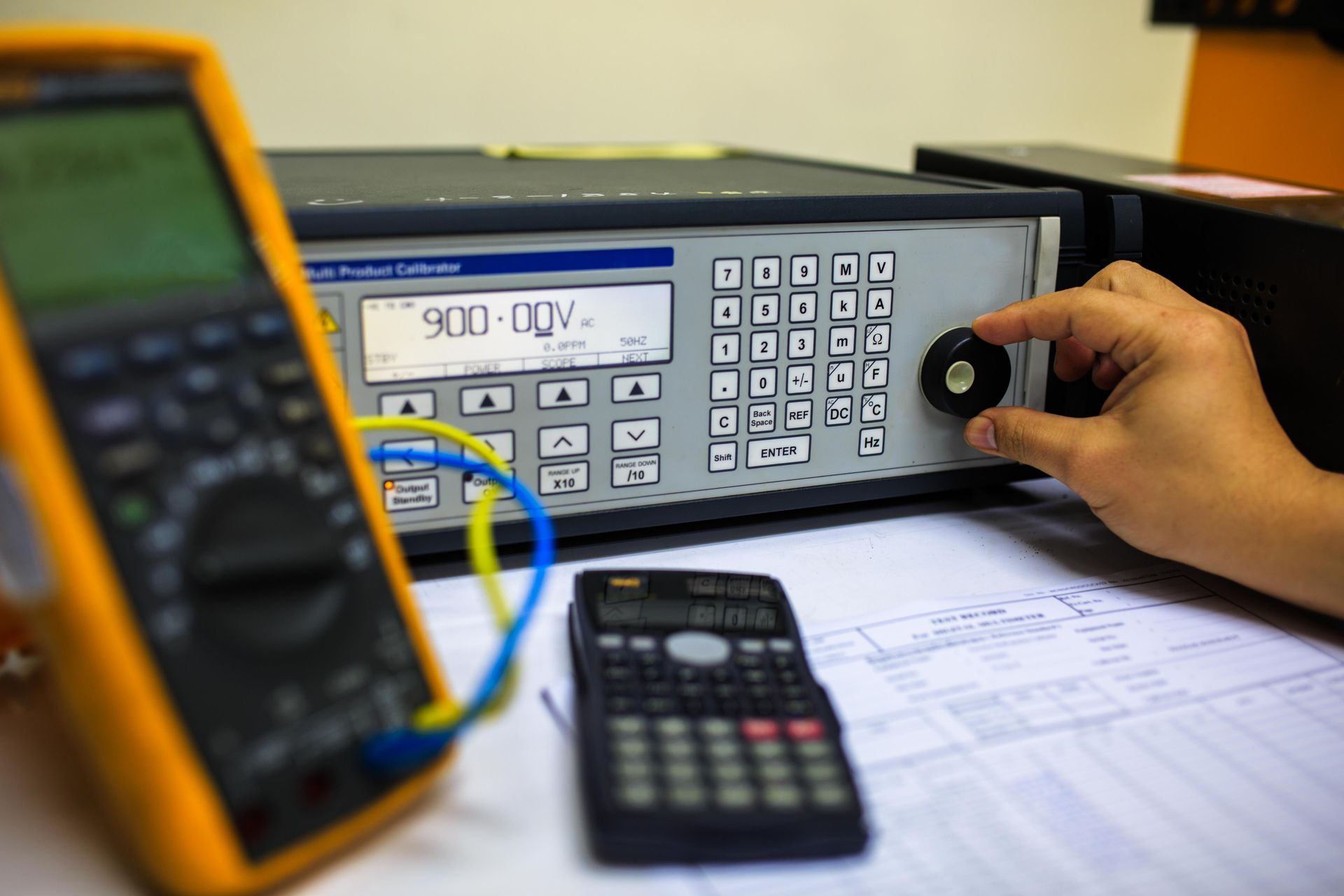 Technician turns the switch of the precision multi calibrator for calibration multimeter. Technician turns the switch of the precision multi calibrator for calibration multimeter.