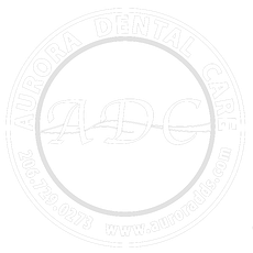 Faint circular logo for “Aurora Dental Care” with ADC initials and website text