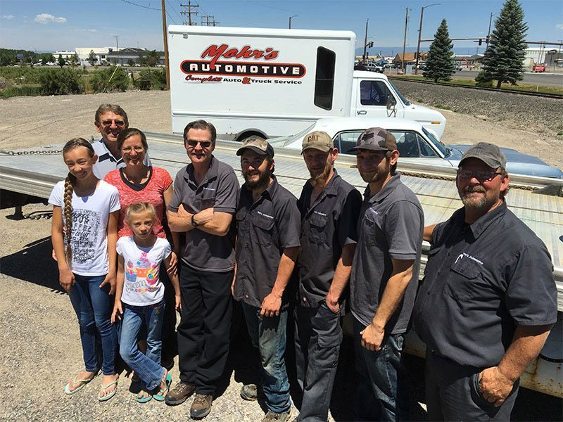 Group of people posing in front of a white truck | Mohr's Automotive