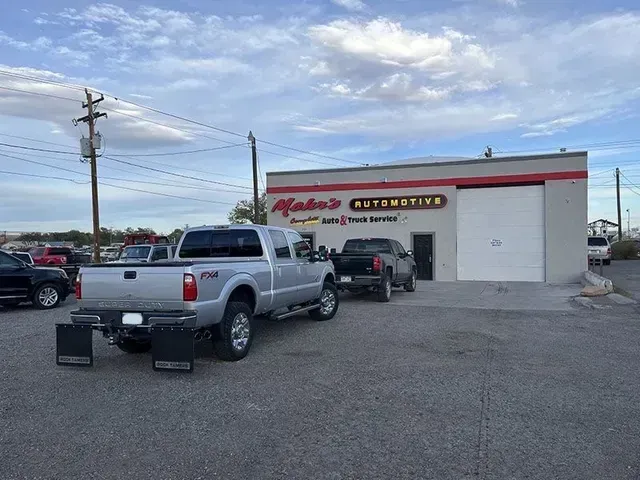 Silver pickup truck parked in front of Mako's Automotive, a tan building. Several other vehicles are in view. | Mohr's Autmotive