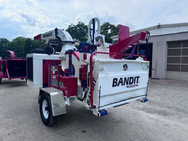 A bandit tree chipper is parked in a parking lot