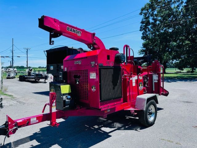 A red ranger tree chipper is parked in a parking lot