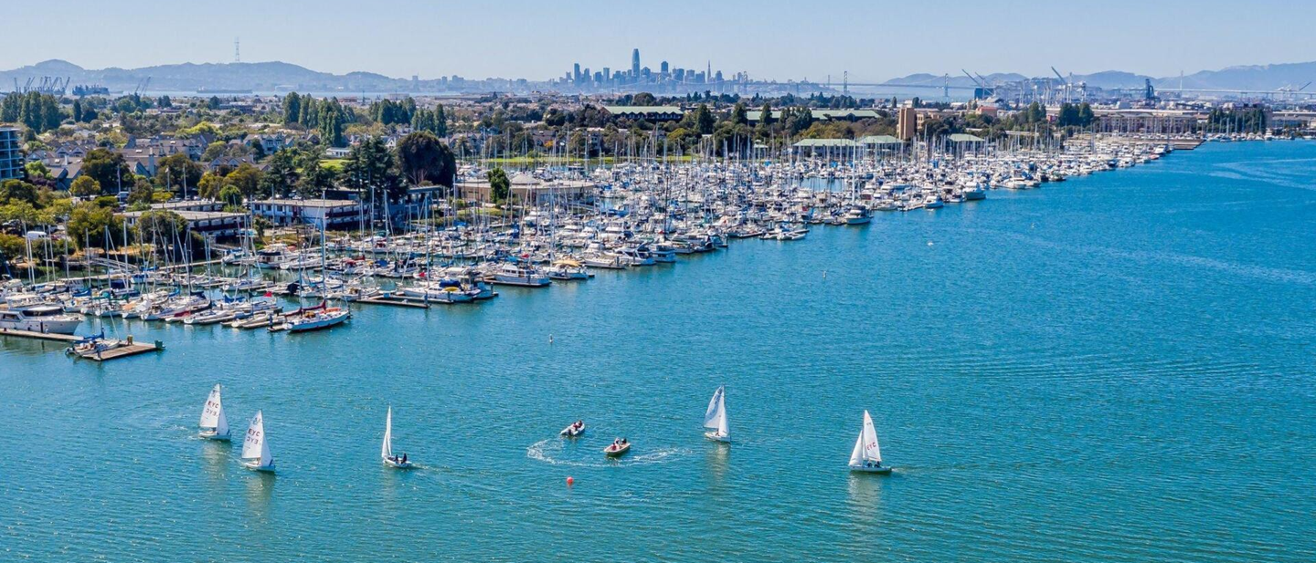 A group of sailboats are floating on top of a large body of water.