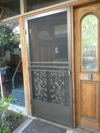 Wooden and glass front door with a screened panel and adjacent narrow window panel