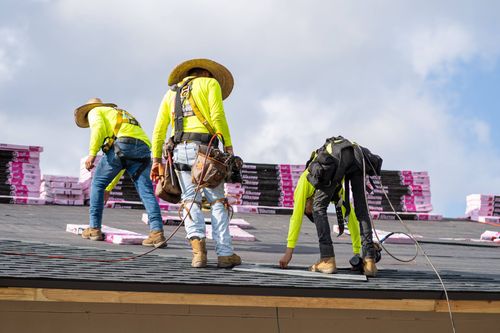 JT Roofing team installing shingles in Melbourne, FL