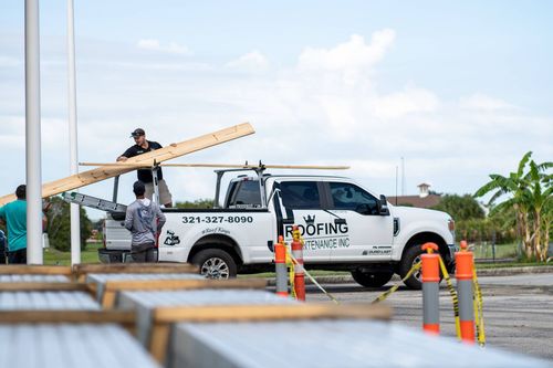 JT Roofing team loading truck in Melbourne, FL