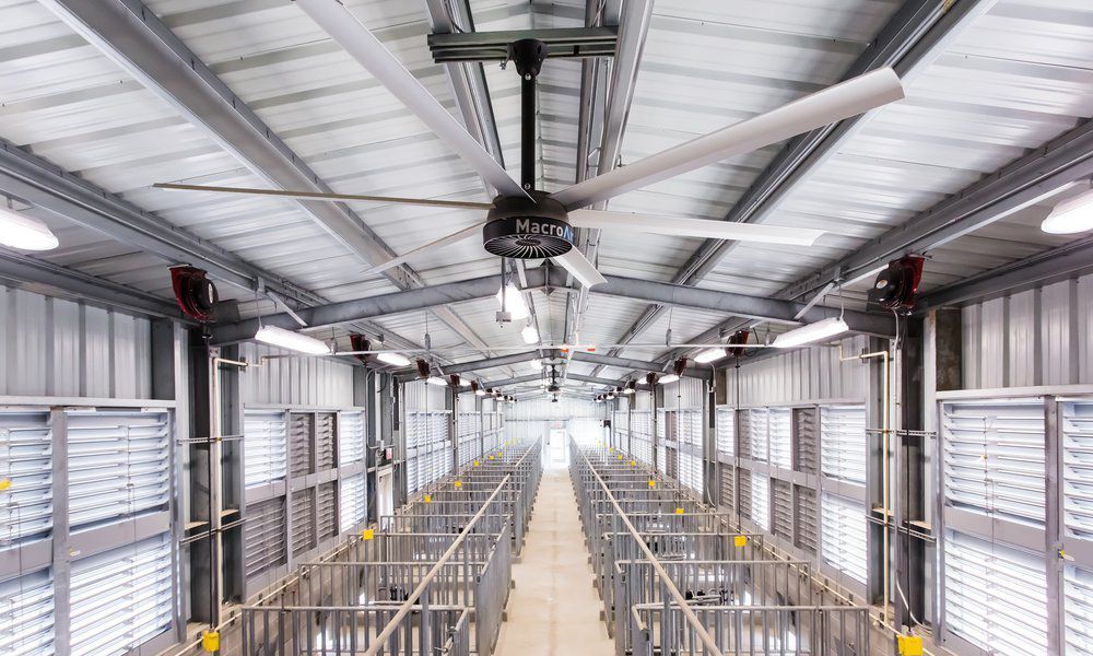 MacroAir fan in a large, bright industrial warehouse.