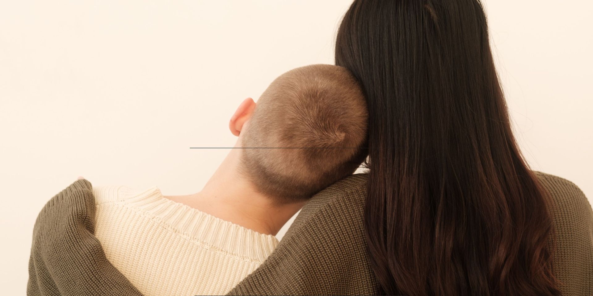 A child resting their head on an adult’s shoulder from behind, symbolizing comfort, protection, and