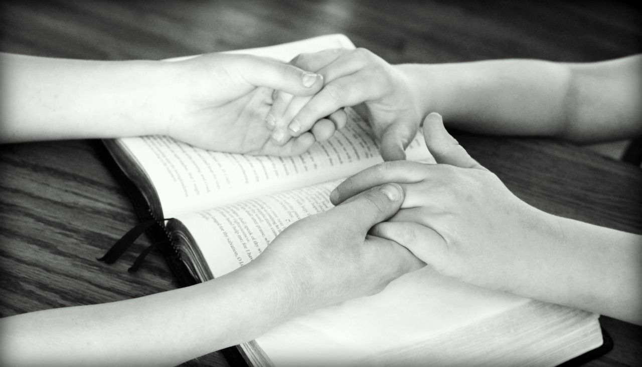People holding hands in prayer, reflecting faith, remembrance, and compassionate cremation services in Edinburg, TX