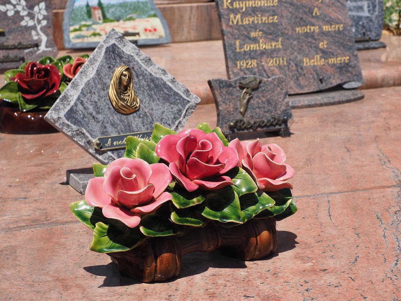 Family grave memorial with headstones and flowers, representing remembrance and lasting tribute thro