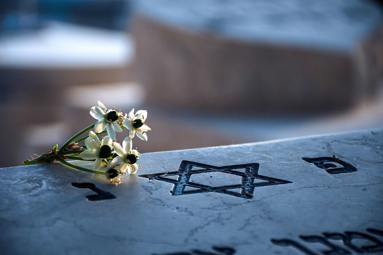 Gravestone in a Jewish cemetery with traditional memorial setting
