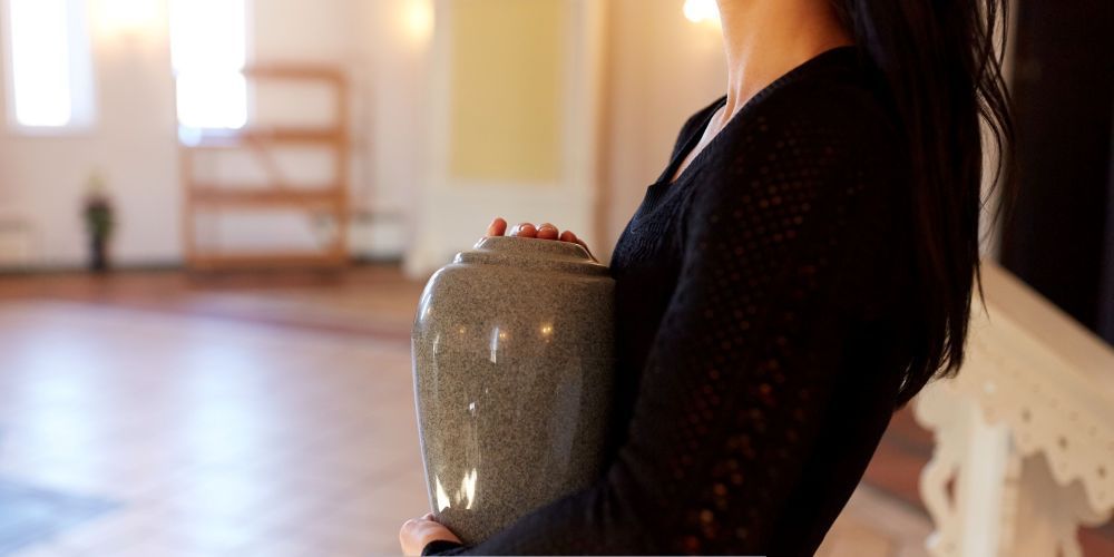 Family member holding a memorial urn after cremation in Pharr, TX.