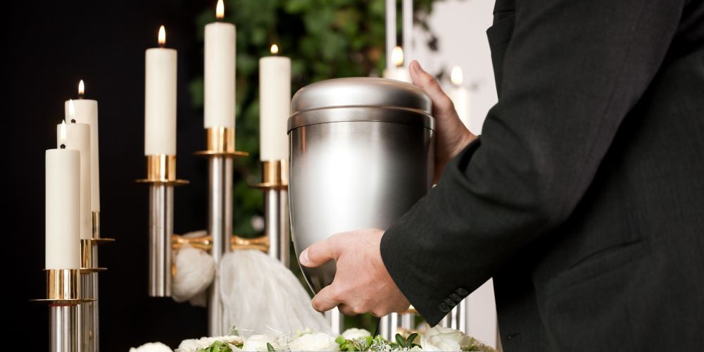 Memorial urn displayed with candles during cremation services in San Juan, TX.