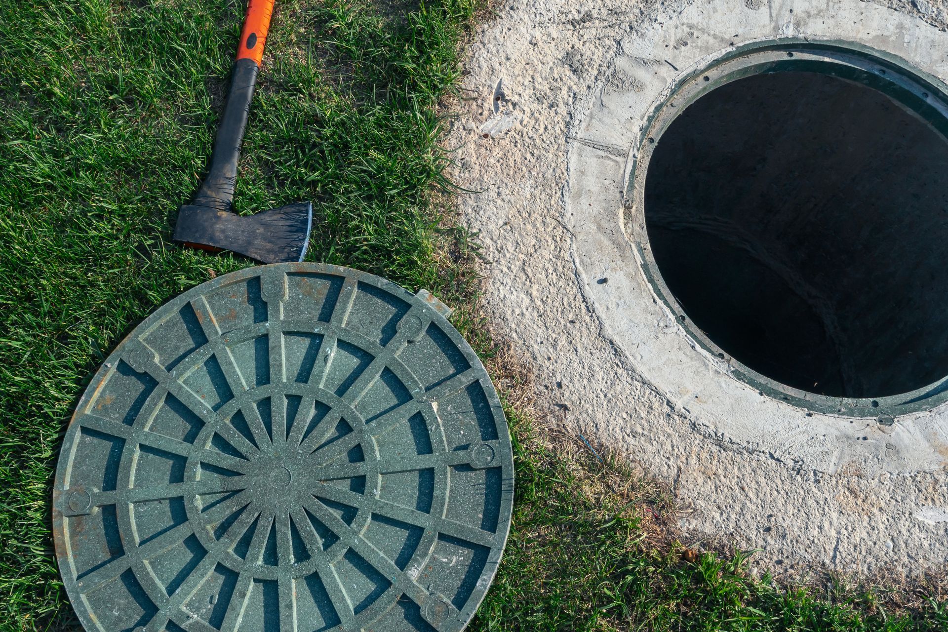 A manhole cover with a visible hole, revealing the opening beneath it.