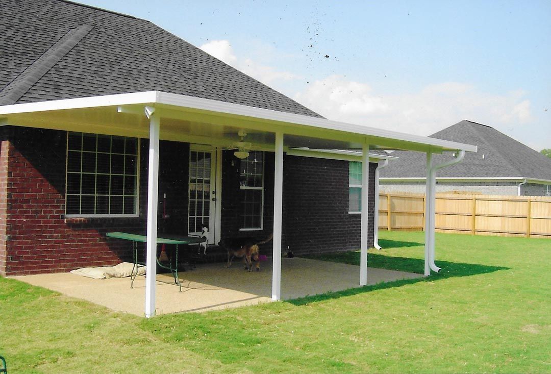 A house with a covered patio in front of it