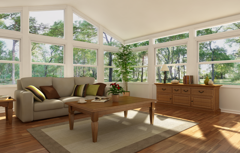 A living room with a couch, coffee table, and lots of windows