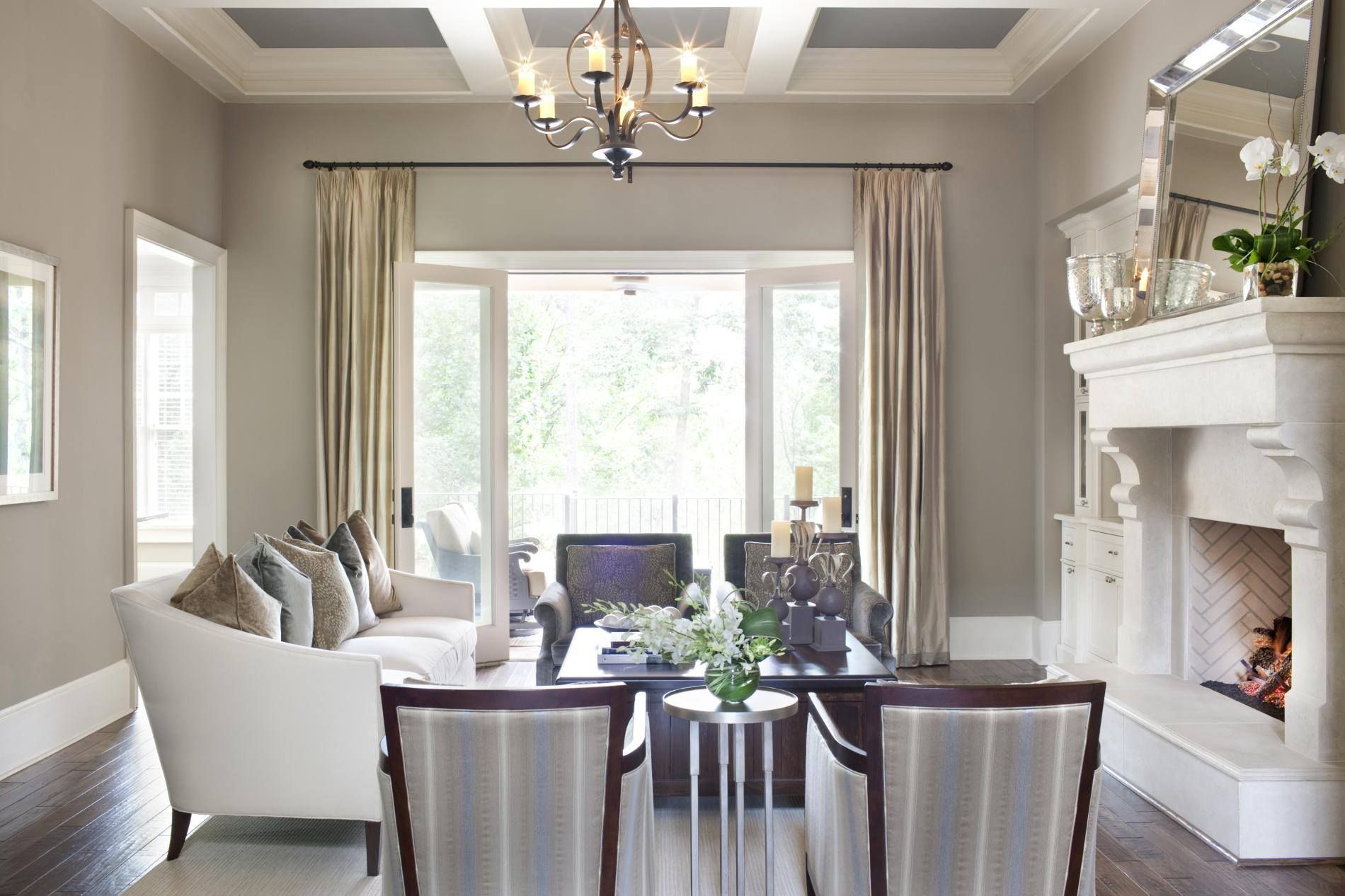A living room with white furniture and a fireplace