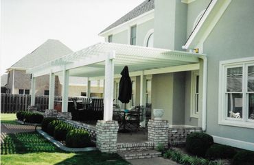 A house with a porch and a black umbrella on it