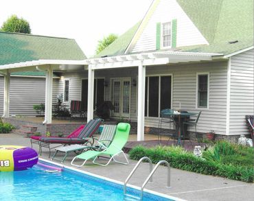 A house with a swimming pool in front of it