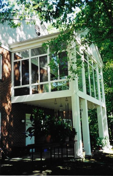 A house with a large porch and lots of windows