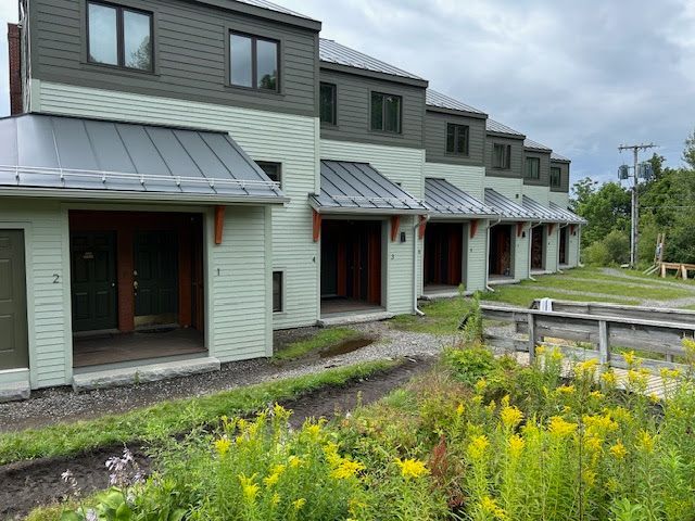 A row of houses are being built in a residential area.