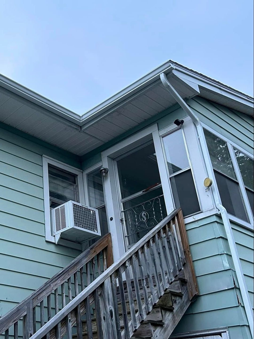 A house with a balcony and stairs leading up to it.