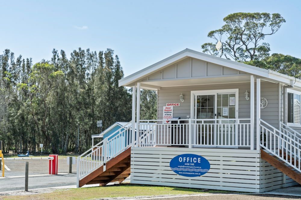 Office Building with Stairs, White Railings, and A Blue Sign — SeaChange Parks Milton in Lake Conjola, NSW