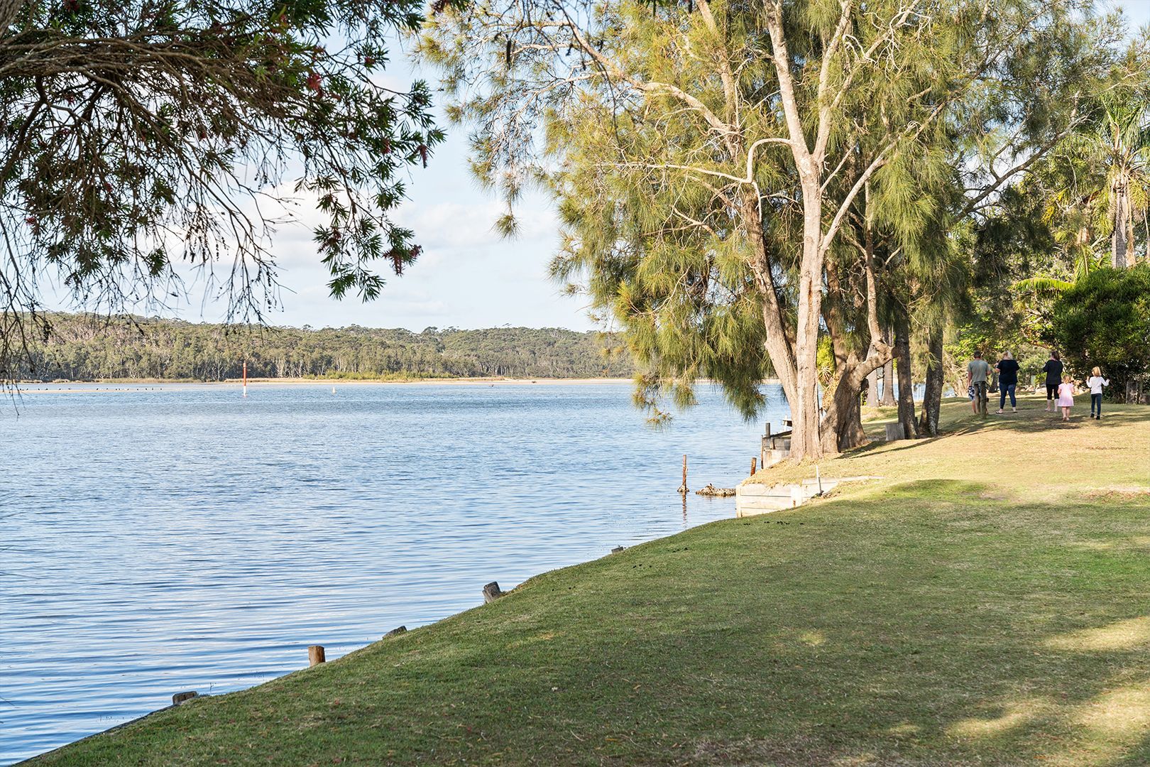 Lakeside Park with Trees and Grass, People Walking Along the Shore — SeaChange Parks Milton in Lake Conjola, NSW