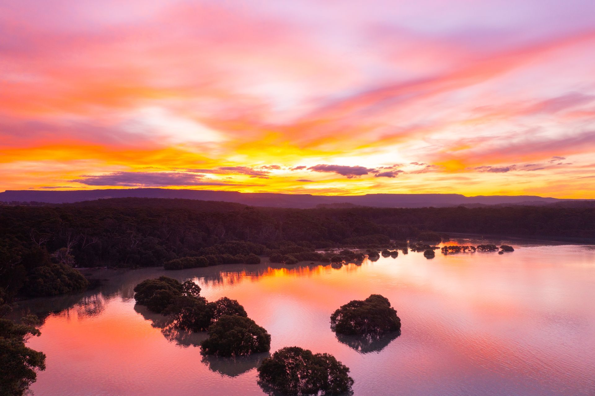 Vibrant Sunset with Orange and Purple Clouds Reflected in A Lake — SeaChange Parks Milton in Milton, NSW