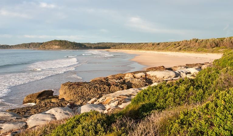A Scenic Sandy Beach Meets the Ocean, Framed by Low, Rocky Tide Pools — SeaChange Parks Milton in Milton, NSW