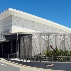 Modern Building With White Angled Roof, Gray Facade, and Decorative Screen — SeaChange Parks Milton in Milton, NSW