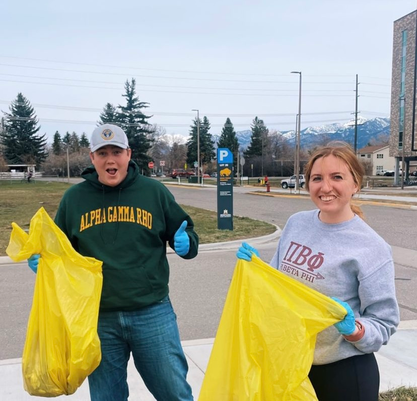 A brother from Alpha Gamma Rho and a sister from Pi Beta Phi standing outside Hyalite Hall