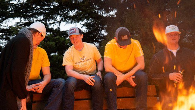 Brothers sitting around a fire