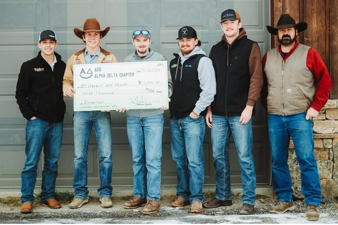 Brothers delivering a check to Heroes and Horses