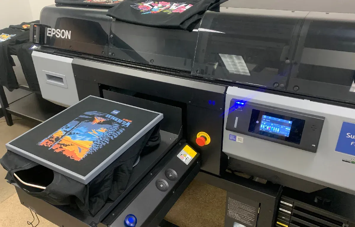 Epson printer printing a colorful design onto a phone case on a production line
