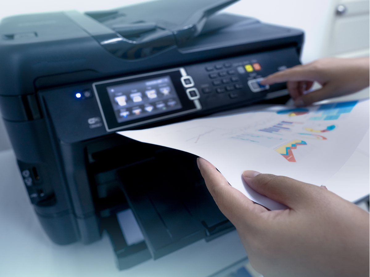 Hands printing a color document from a multifunction printer touchscreen