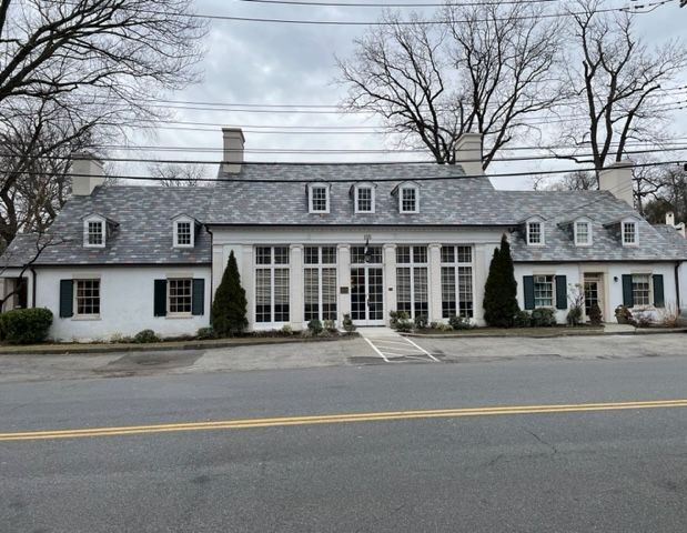 A blue house with a blue roof and white trim