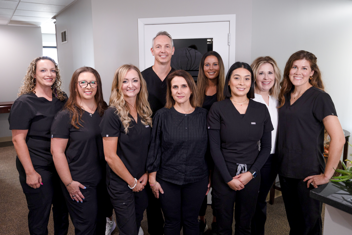 A group of people standing next to each other in a dentist office