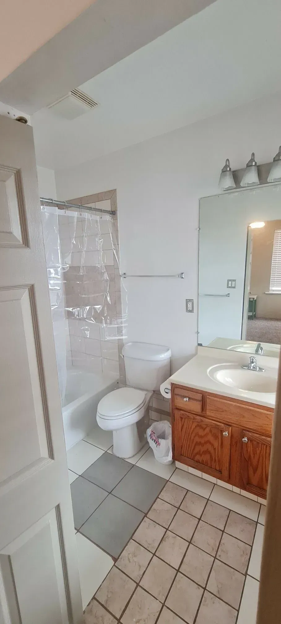 A bathroom with a toilet , sink , and shower.