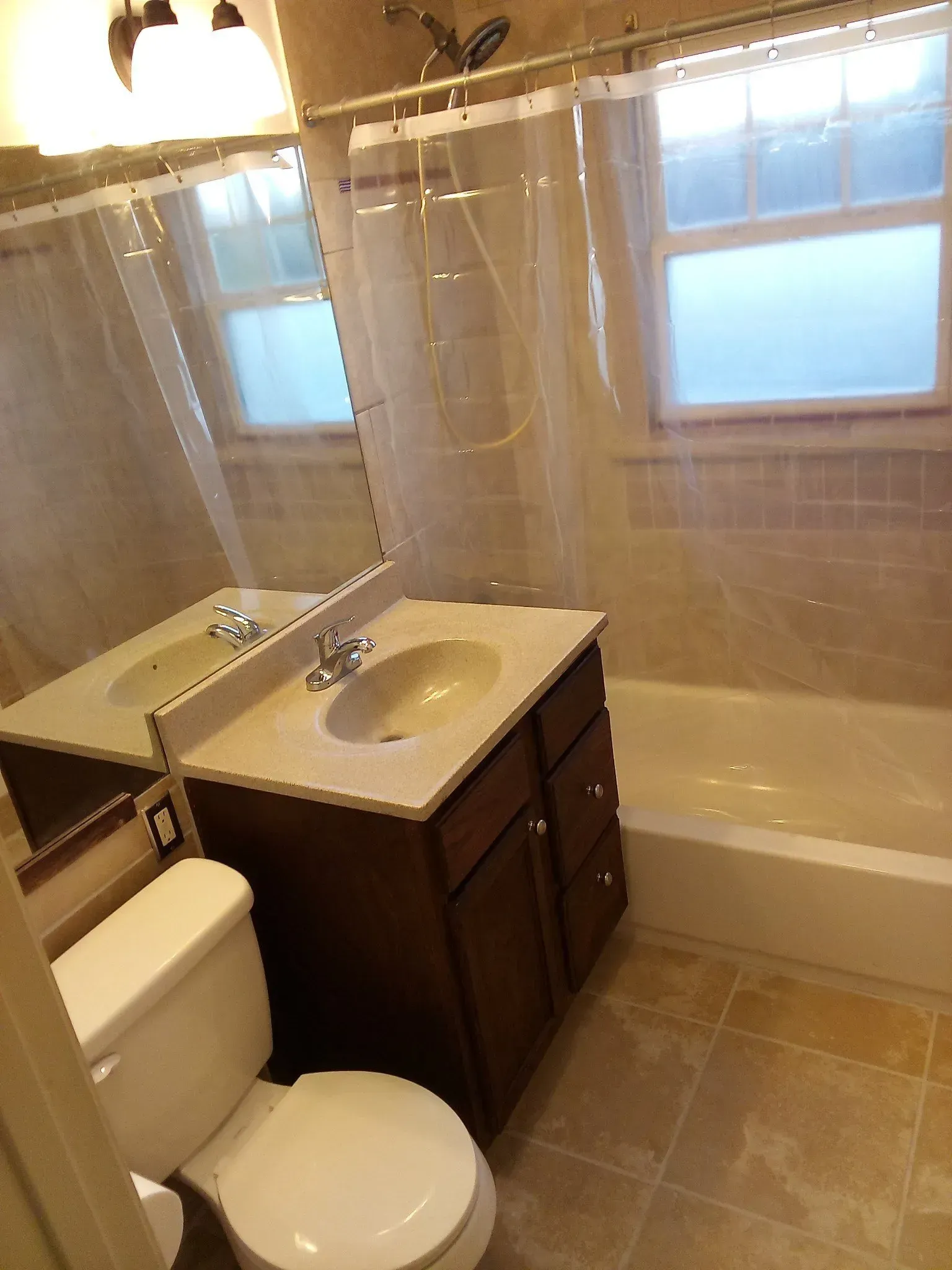 A bathroom with a toilet a sink and a bathtub