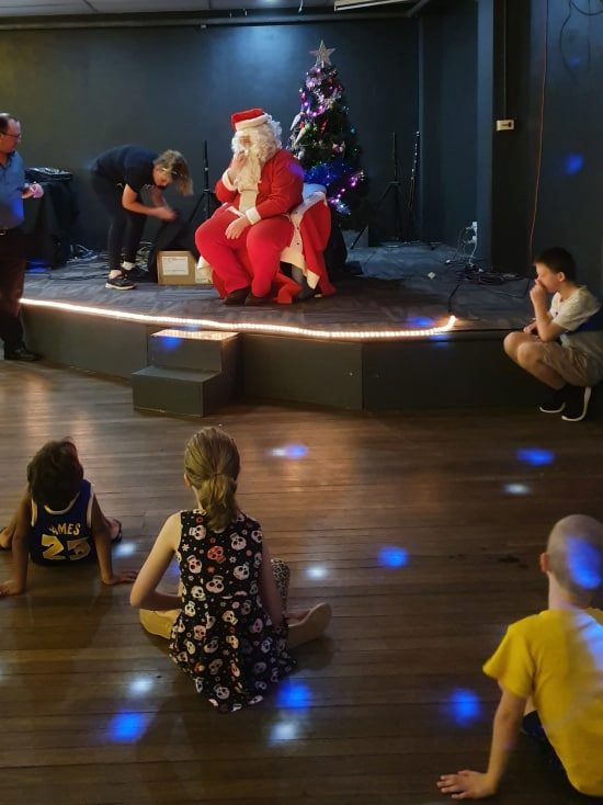 Santa Seated on a Small Stage — Tennant Creek Memorial Club & Steak House in Tennant Creek, NT