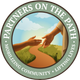 Circular logo with hands meeting over a path and the text “Partners on the Path” and “Mobilizing Community · Lifting Lives”