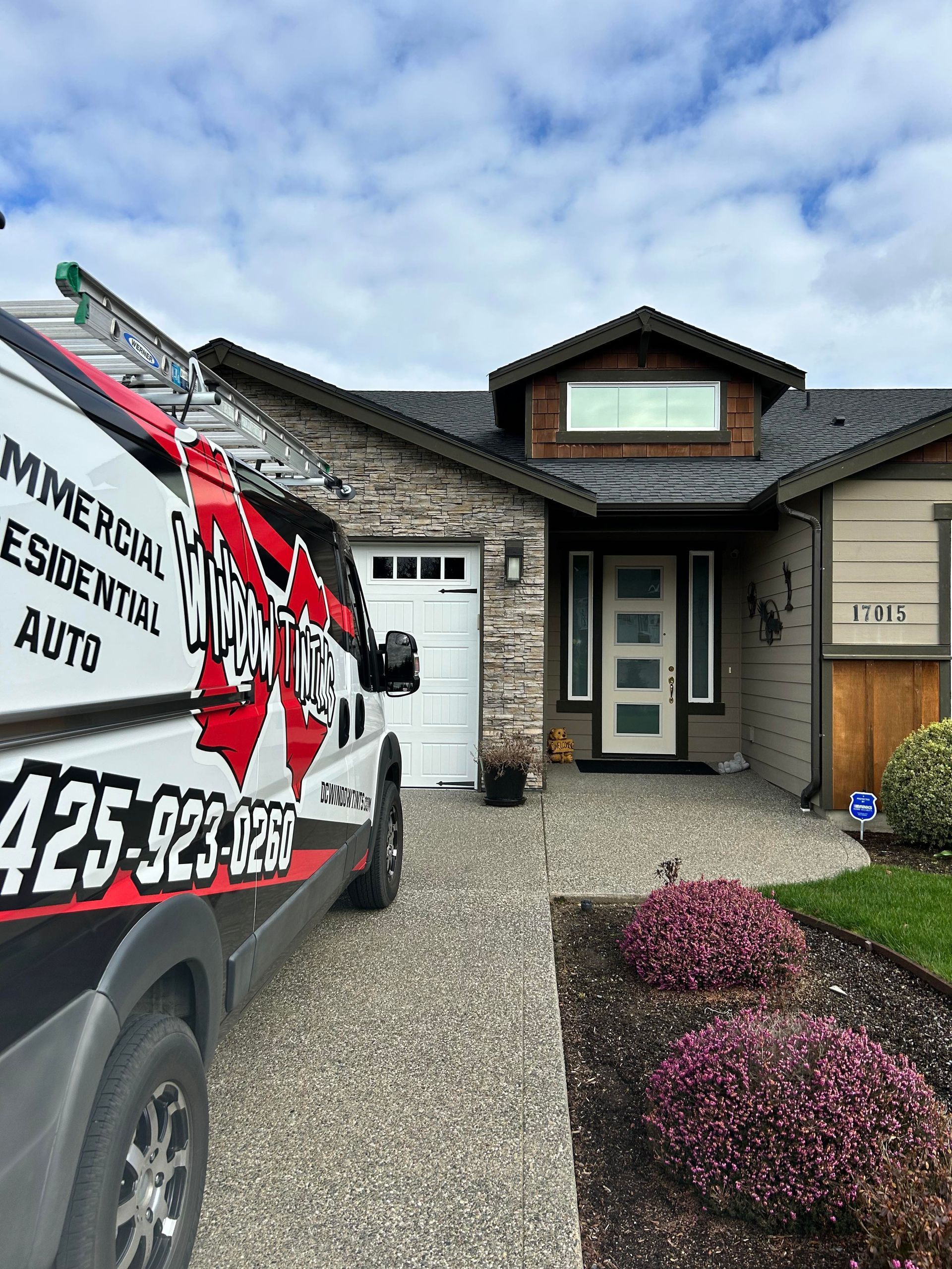 Minnie’s Exterior Services truck parked outside a suburban house with a front door and stone walkway.