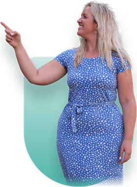 Woman in a blue dress points left and smiles against a pale teal background
