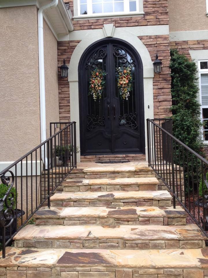 The front door of a house has a wreath on it