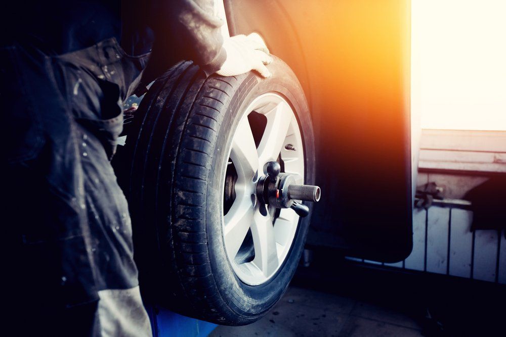 Repairman Balances the Wheel — GK Denney Tyres in Coffs Harbour, NSW