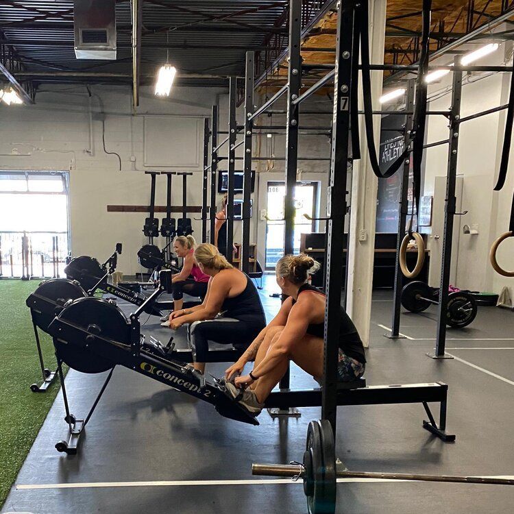 A group of women are doing exercises in a gym
