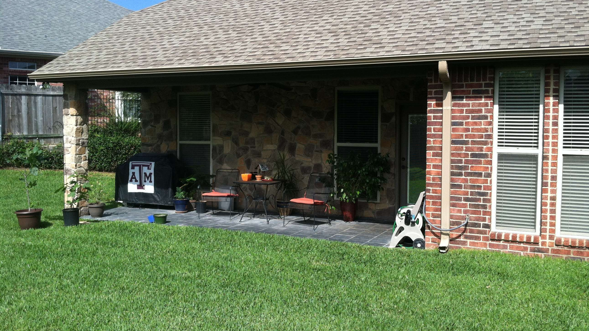 A brick house with a patio in front of it