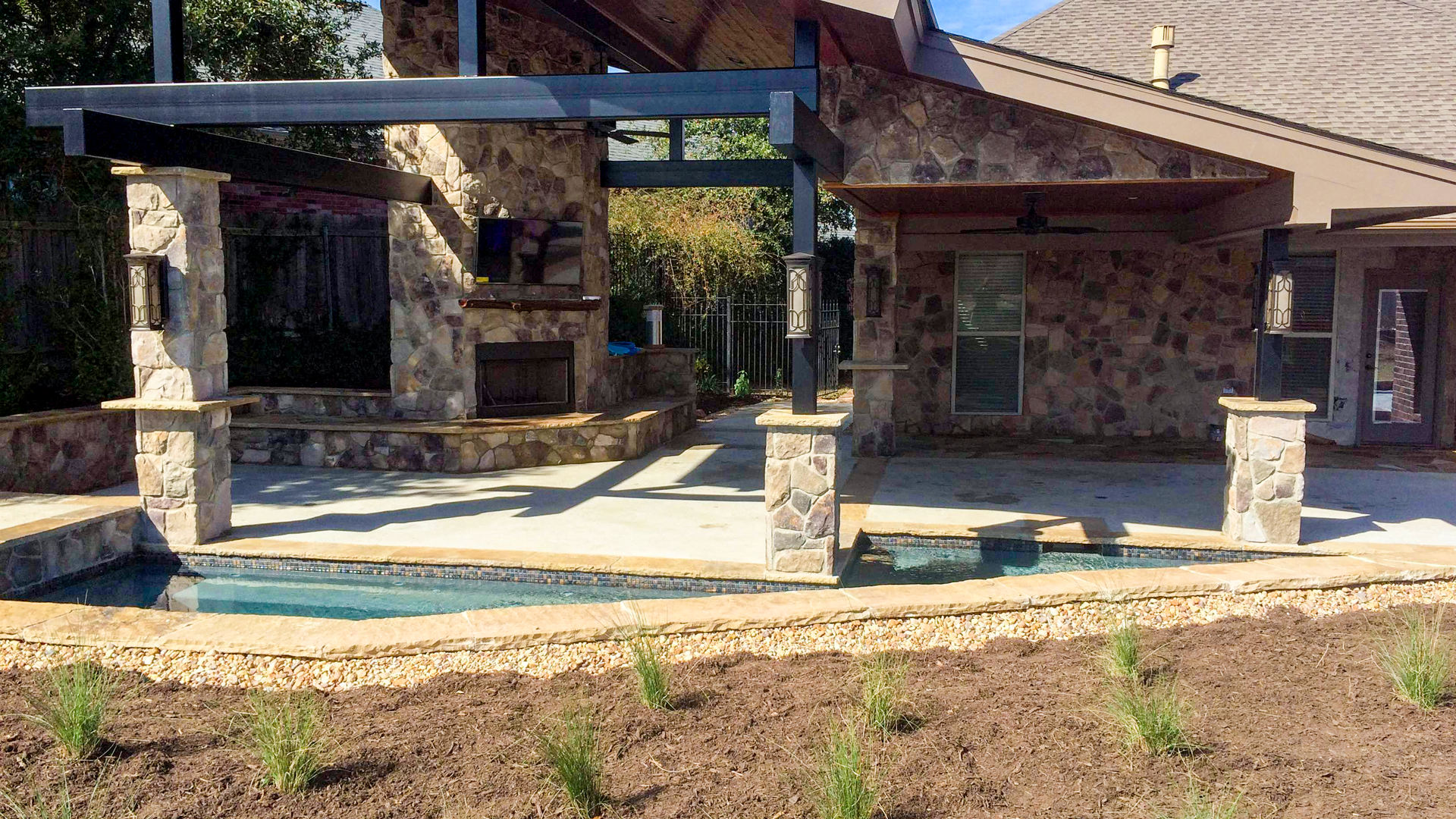A house with a pool and a pergola in front of it.
